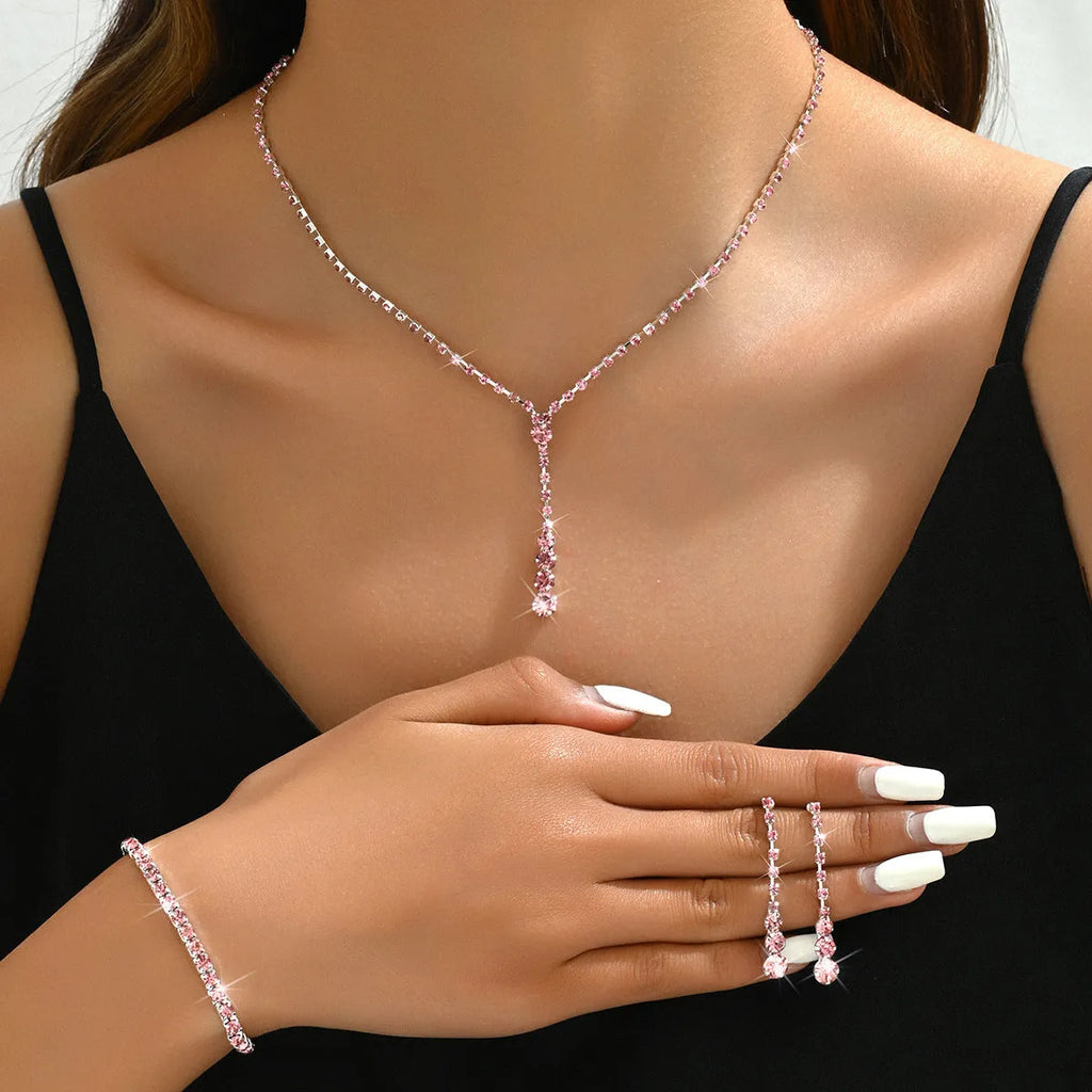 Women's rhinestone wedding jewellery set with heart pendants and tassel details in silver, rose gold, black, or pink
