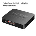 HDMI splitter device with one input and two output ports, USB charger lead, and compact black housing