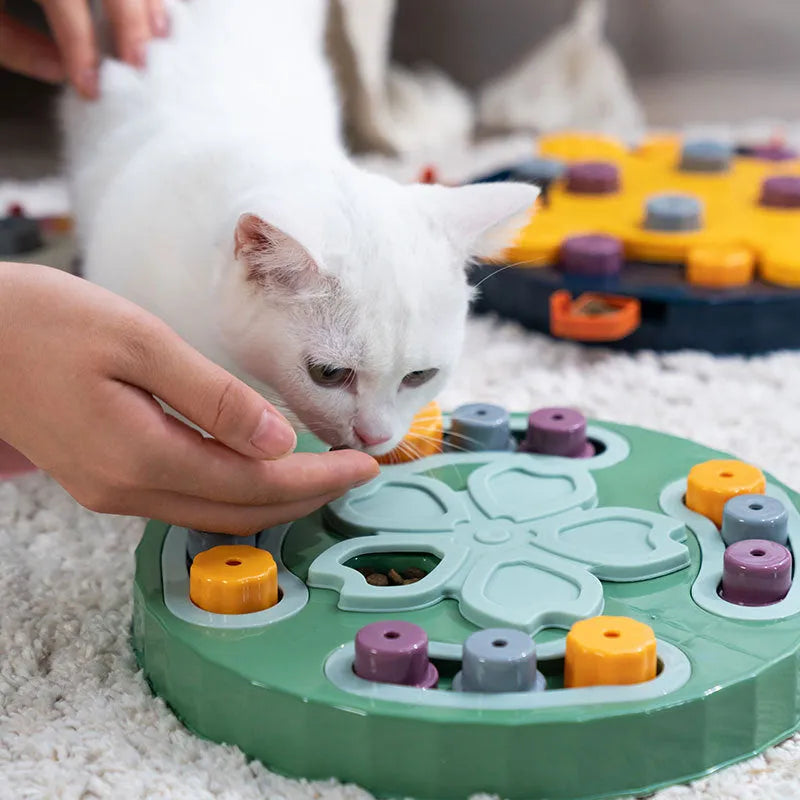 Blue silicone dog slow feeder mat with puzzle grooves and a suction base on a kitchen floor.