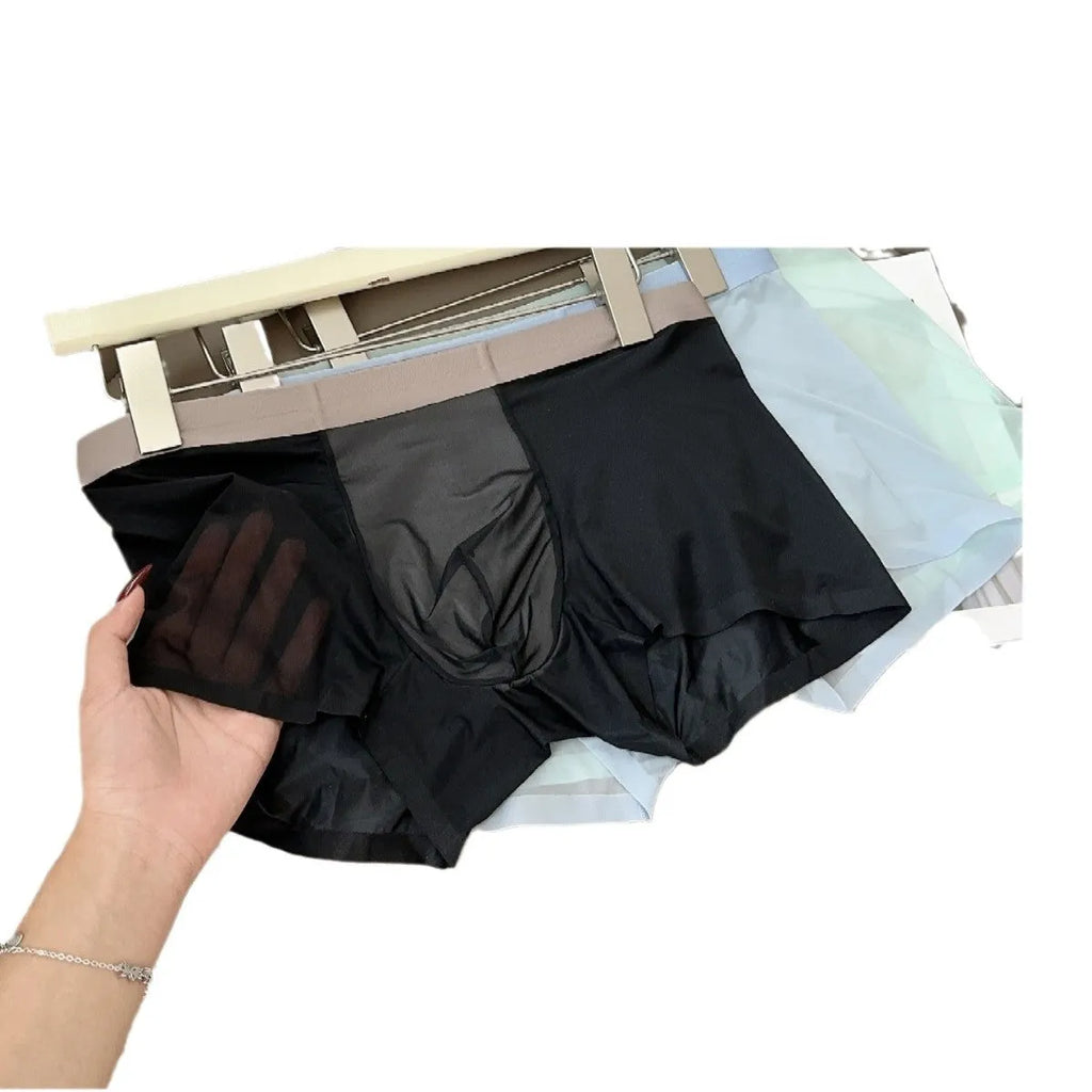 Ultra-thin seamless men's boxers in mid-waist design with honeycomb crotch, available in multiple colours like black and bright red.