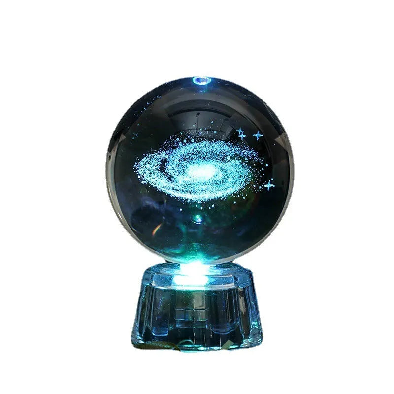 Transparent 6cm white crystal ball ornament with inner carving patterns illuminated by small night lamp on tabletop