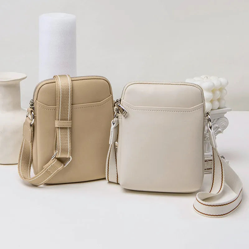 Solid colour mobile phone crossbody bag with adjustable strap, compact 14.5x5.5x19cm dimensions