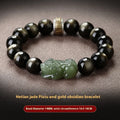 Natural rainbow eye obsidian and stone bracelet in gold or jade colours on a white background.
