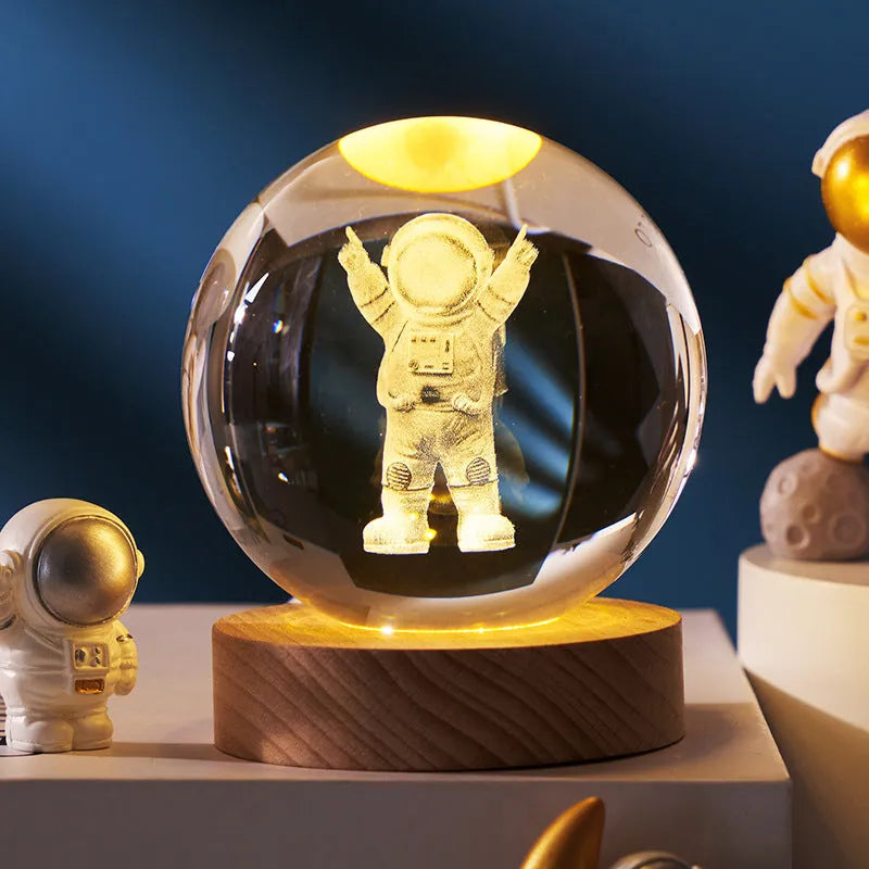 3D crystal ball night light projecting starry sky and planets from its 6cm sphere on a solid wood base.