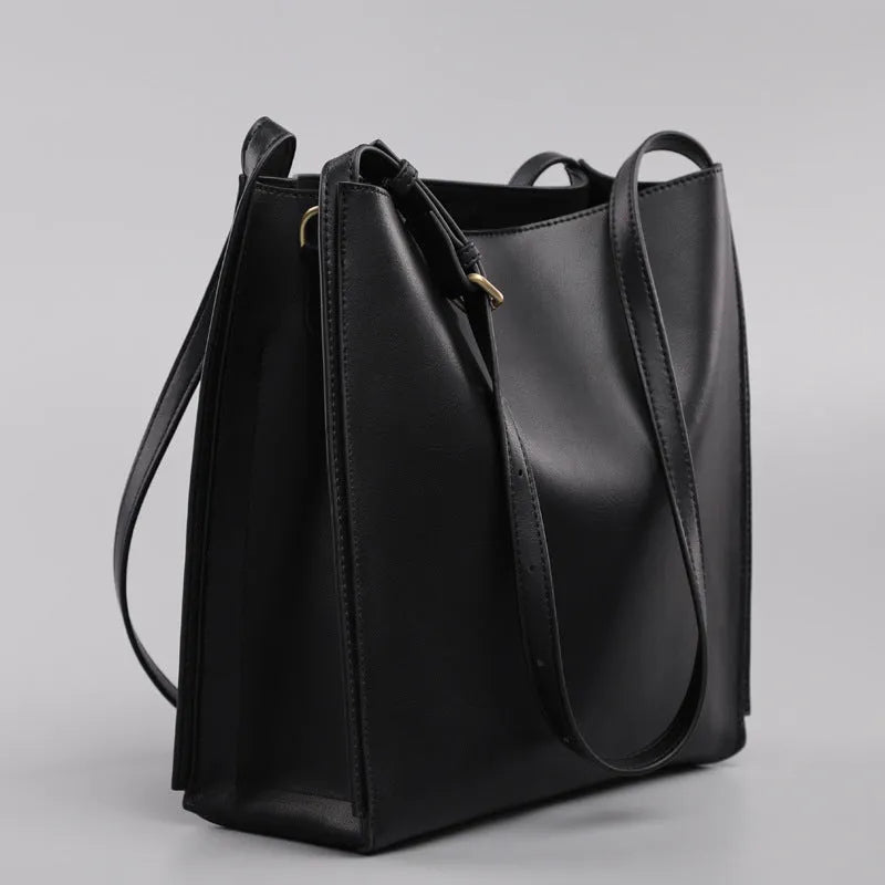 Genuine leather women's commuter bag in brown bucket design with organised internal compartments