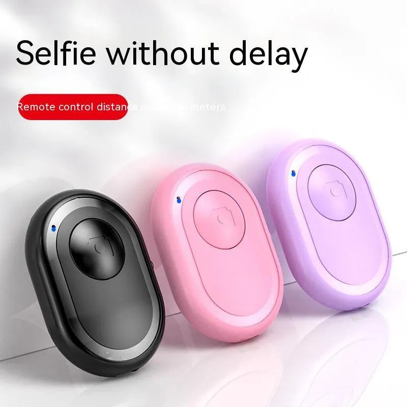 Bluetooth remote control for smartphones with self-timer, showing black, pink and purple colour options