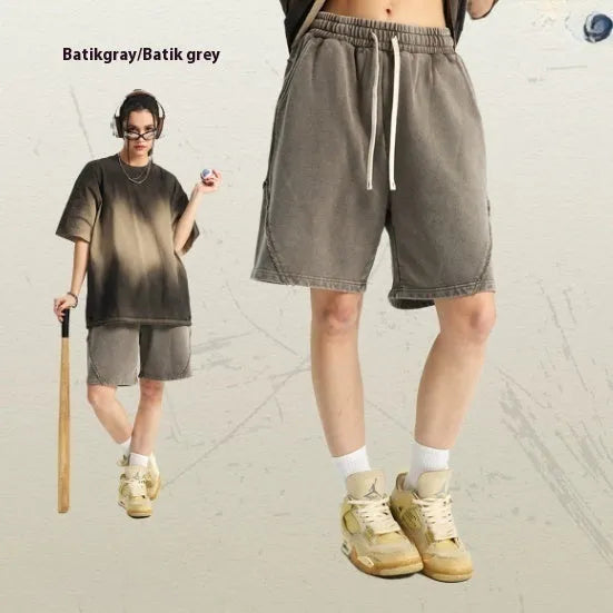 Men's loose fit retro shorts in batik washed cotton terry fabric, showing patch craft detail.