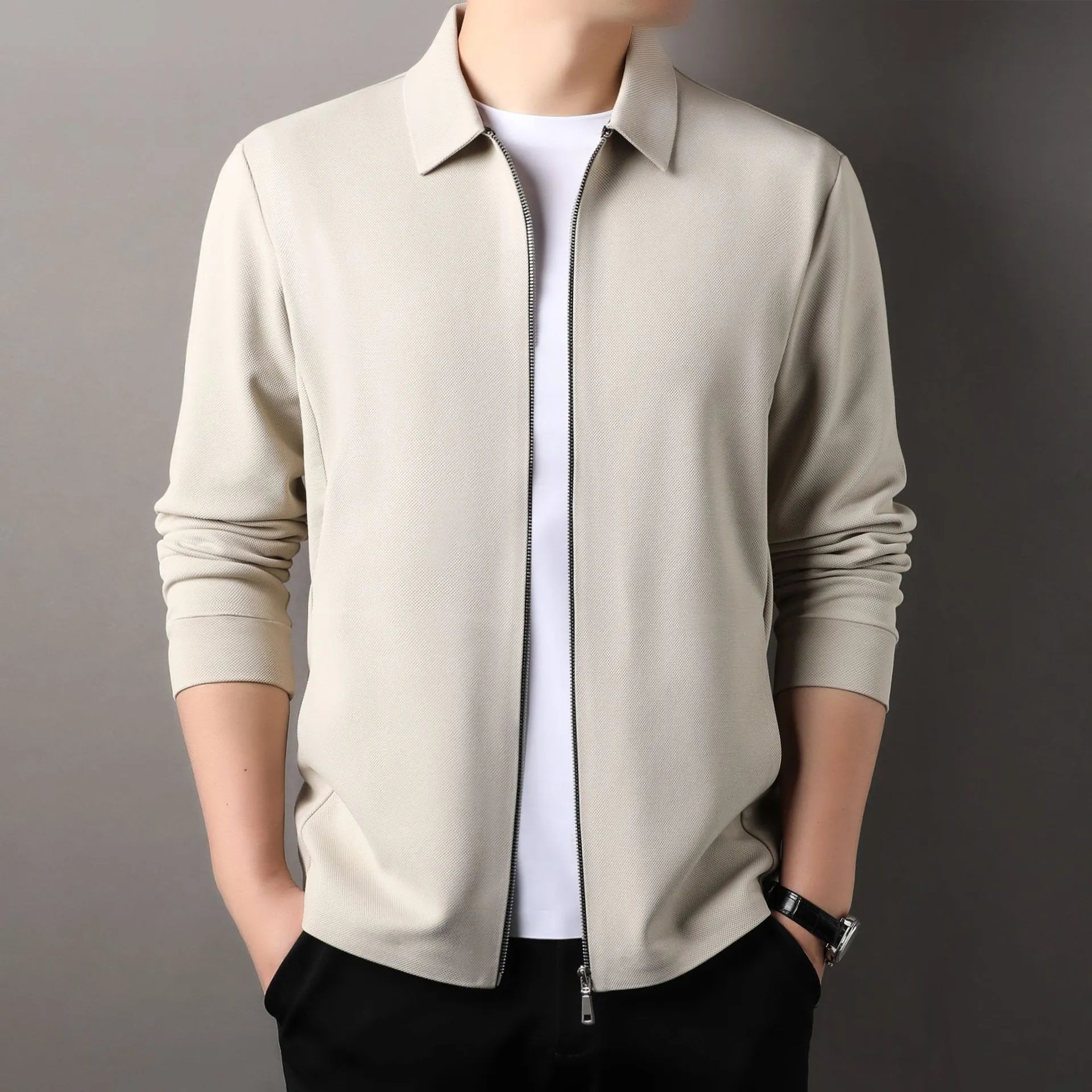 Men's jacket in apricot colour with straight hem and long sleeves, made from polyester fibre, shown on a hanger.