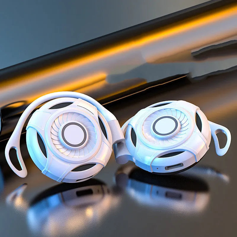 Black and white Bluetooth wireless earphones with hanging ear design showing USB connection option