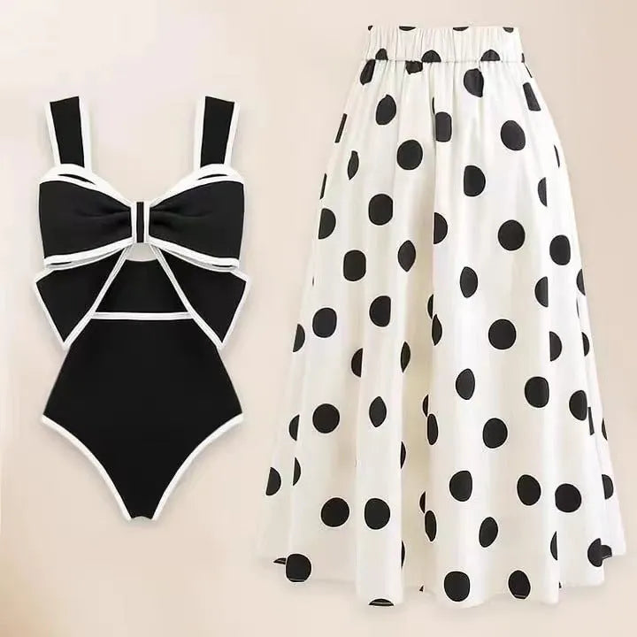Women's black one-piece swimsuit with matching beach dress featuring bow and round skirt design