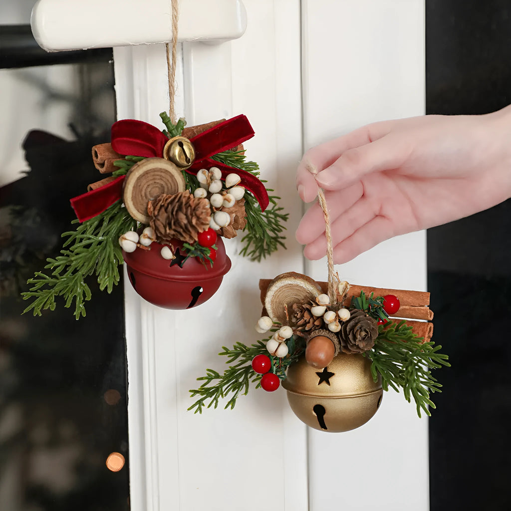 Wrought iron window hanging ornament with a jingling bell, antlers, and pine cone design in a choice of colours.