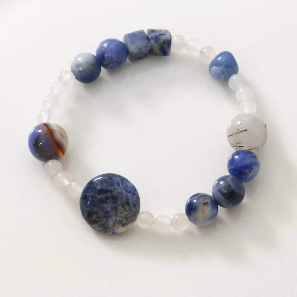 Hand-woven natural stone bracelet with blue point stone and black hair crystal agate in geometric design