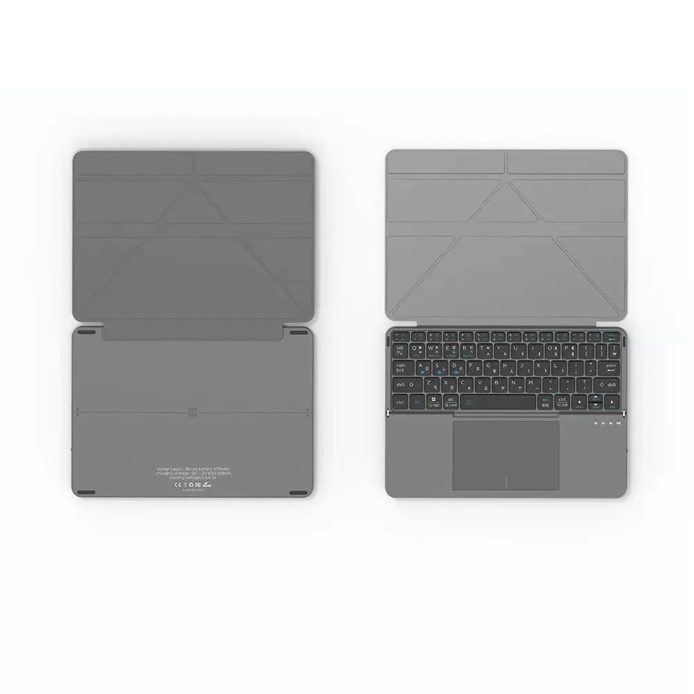 Grey folding Bluetooth keyboard unfolded next to mobile phone showing 60-key layout and compact design