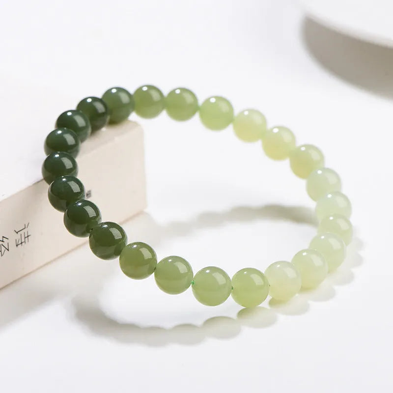 Natural gradient water Hetian jade bracelet with choice of round or barrel beads.
