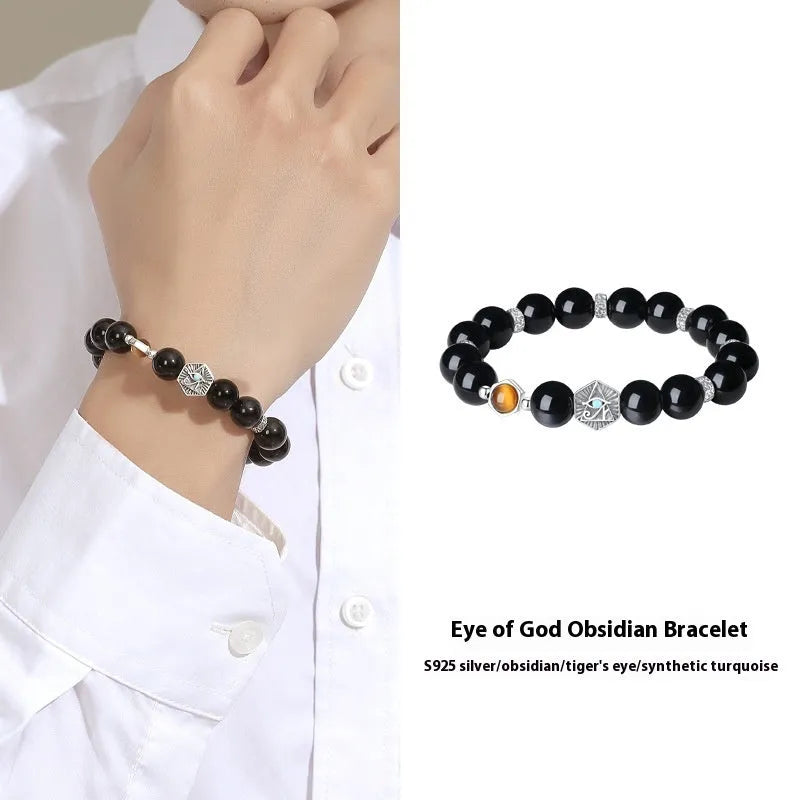 Men's S925 sterling silver bracelet with an 8mm geometric obsidian God's Eye centrepiece on a wrist.