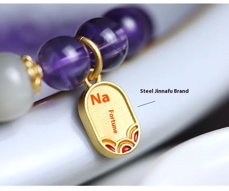 Amethyst purple geometric crystal bead bracelet ornament on a wrist.