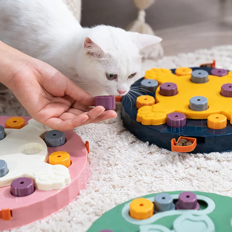 Blue silicone dog slow feeder mat with puzzle grooves and a suction base on a kitchen floor.