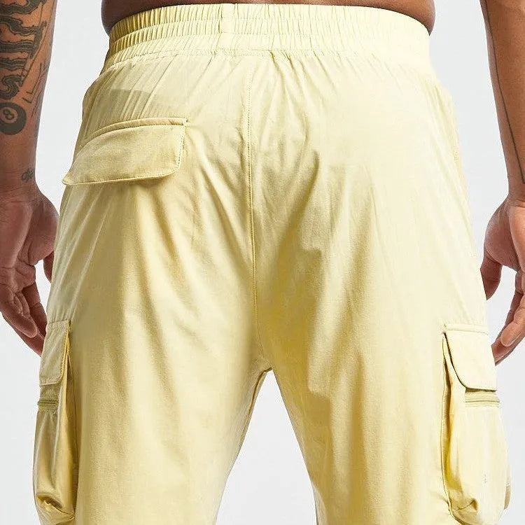 Men's black quick-dry sports shorts with four-sided stretch, shown on a model for running and fitness.