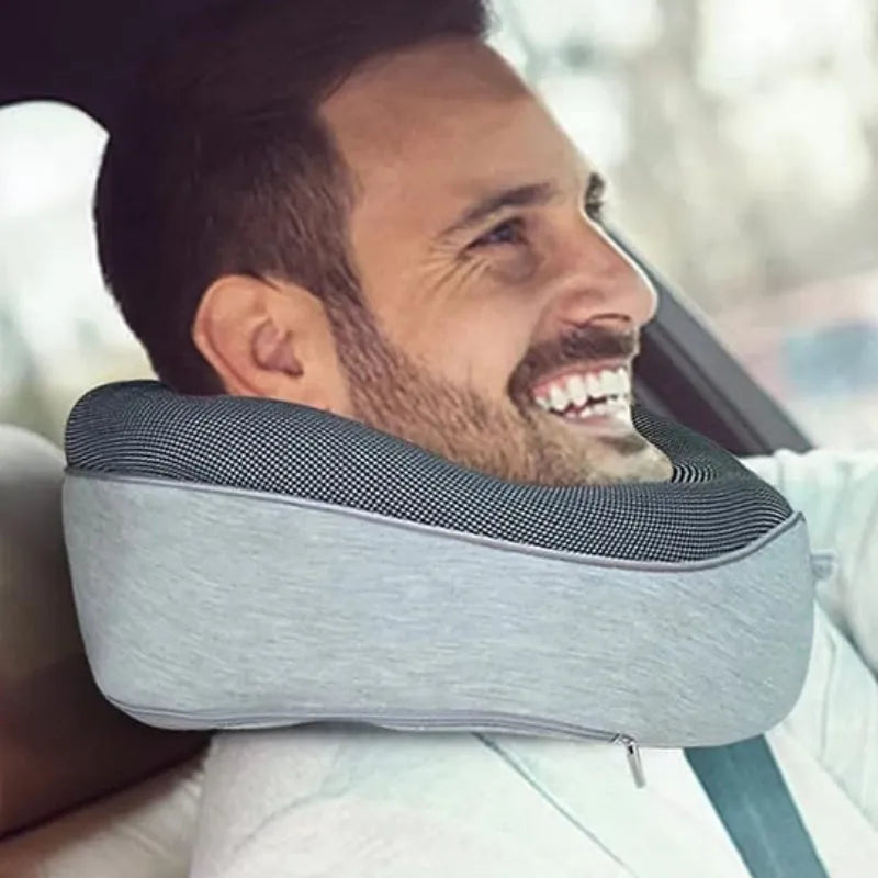 Navy blue U-shaped travel neck pillow with memory foam filling shown rolled and in its carry bag
