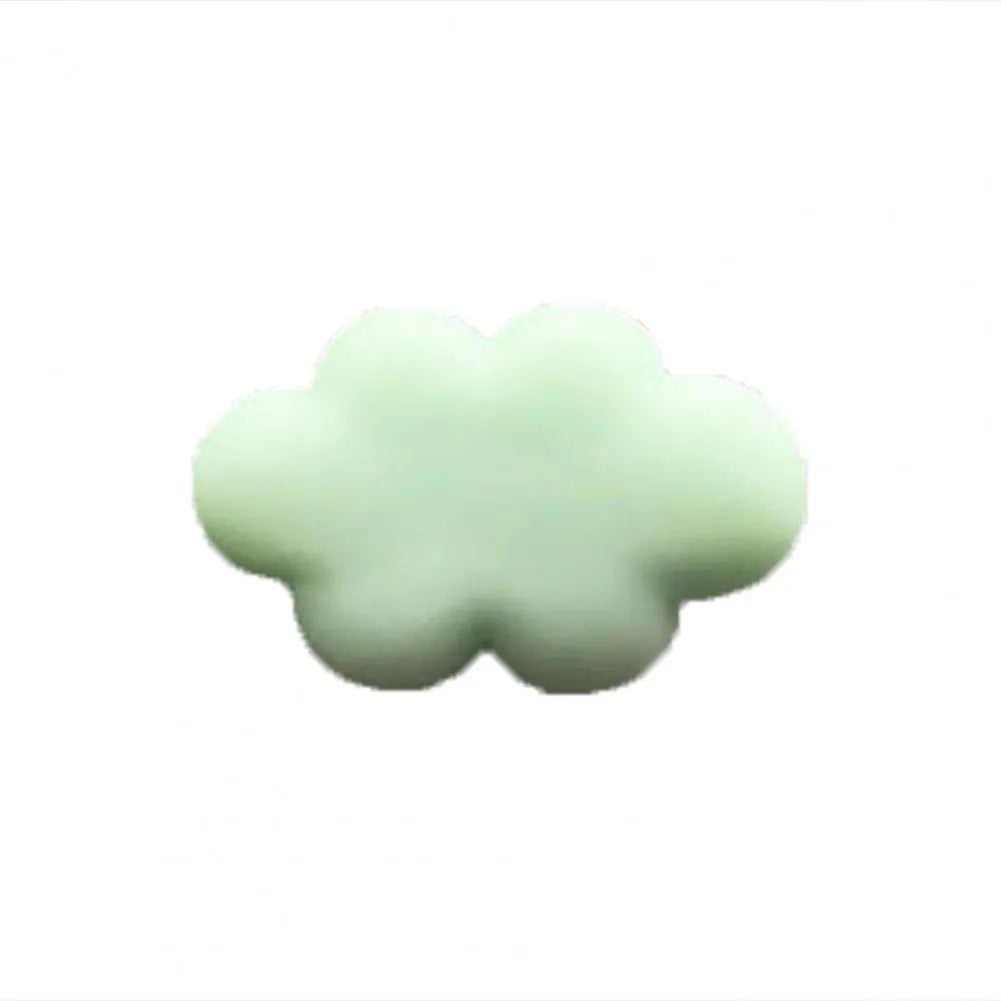 Resin cartoon car fragrance clip in light green colour, dimensions 17mm by 27mm, on a car air vent