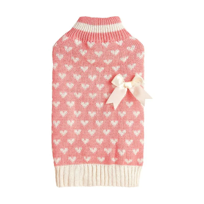 Red love heart dog sweater with bow decoration on a small breed pet, showing acrylic knit and fit