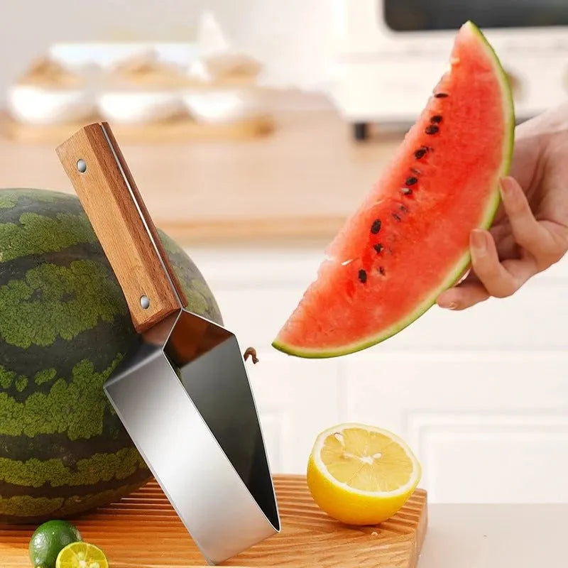 A stainless steel watermelon splitter with triangular blades and a red protective cover on a kitchen worktop.