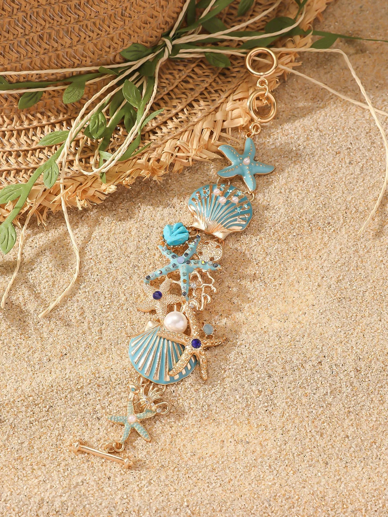 Women's alloy bracelet with starfish design in turquoise, coral red, or coral blue with marine shell and boat anchor elements
