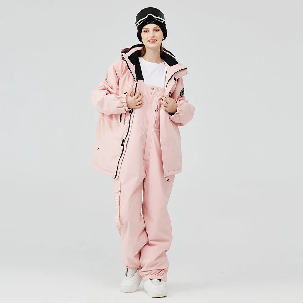 Men's and women's winter ski suit in blue top with grey-blue pants, showing waterproof construction for snow sports