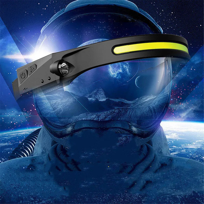 Black silicone USB rechargeable headlamp with a wide LED beam and side wave sensor for outdoor use.