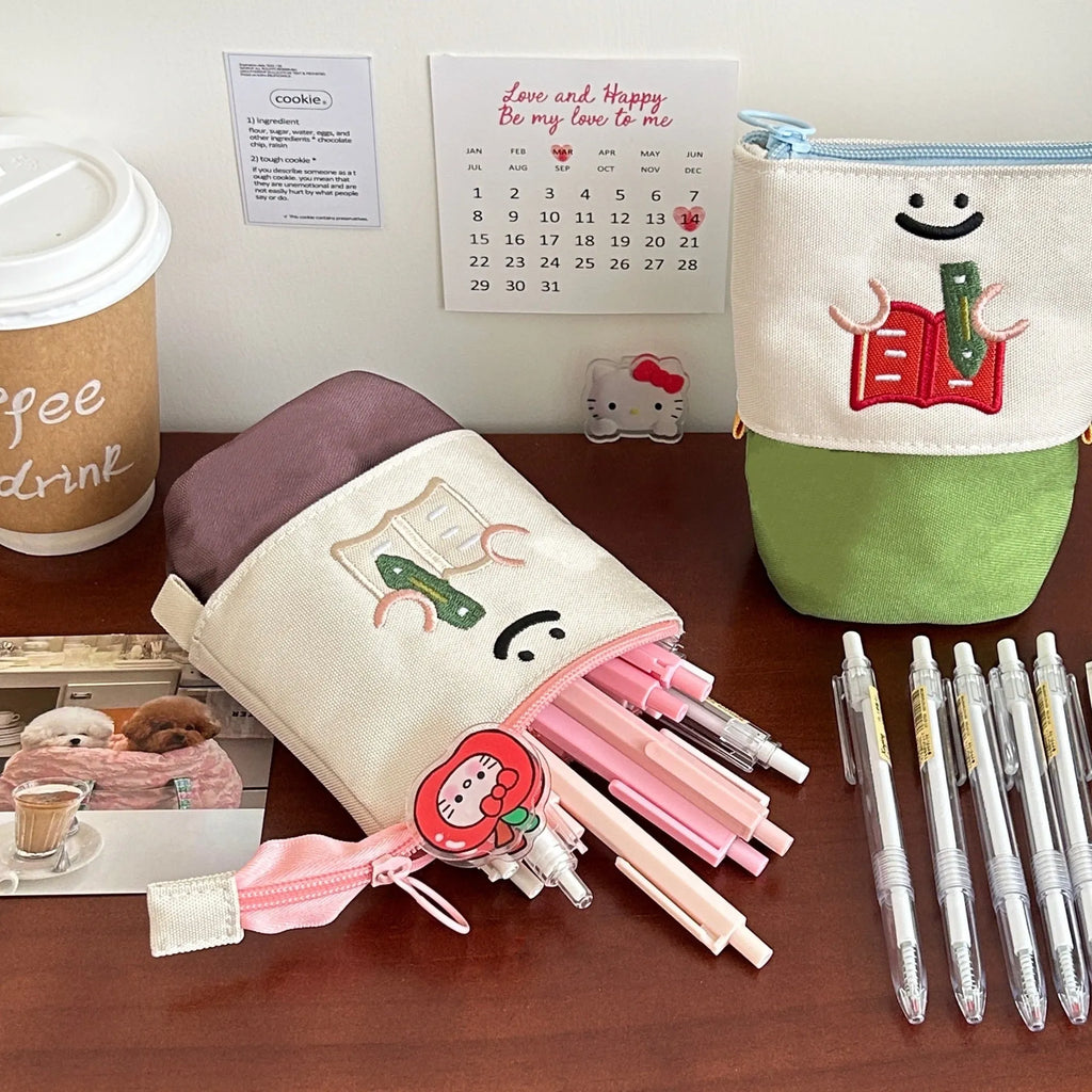Brown collapsible pencil case with Korean-style cartoon design showing 17x14cm dimensions and Oxford fabric texture