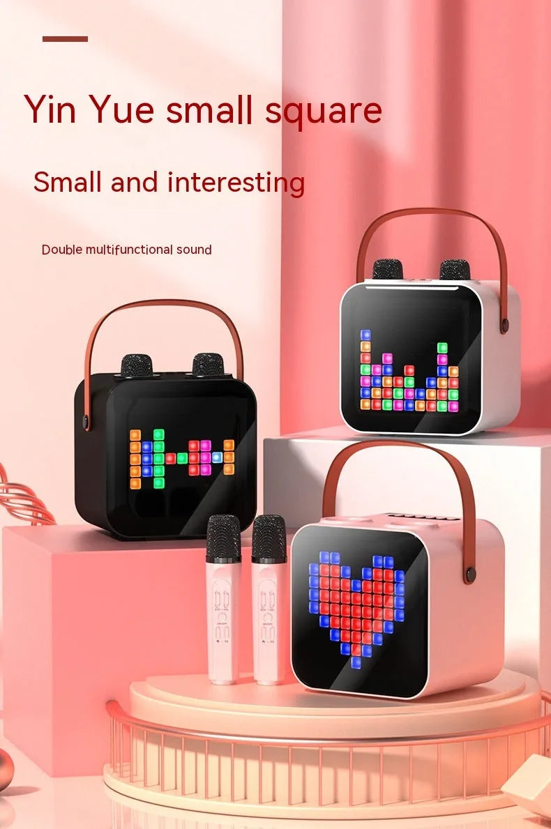 Portable Bluetooth karaoke speaker in black with two wireless microphones, 15W output, RGB rhythm light, and iron mesh front.