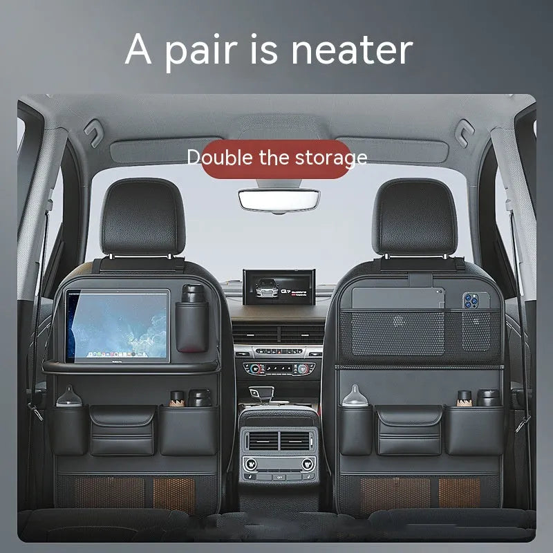 Black leather car seat storage bag with a foldable dining table deployed, hanging behind a car headrest