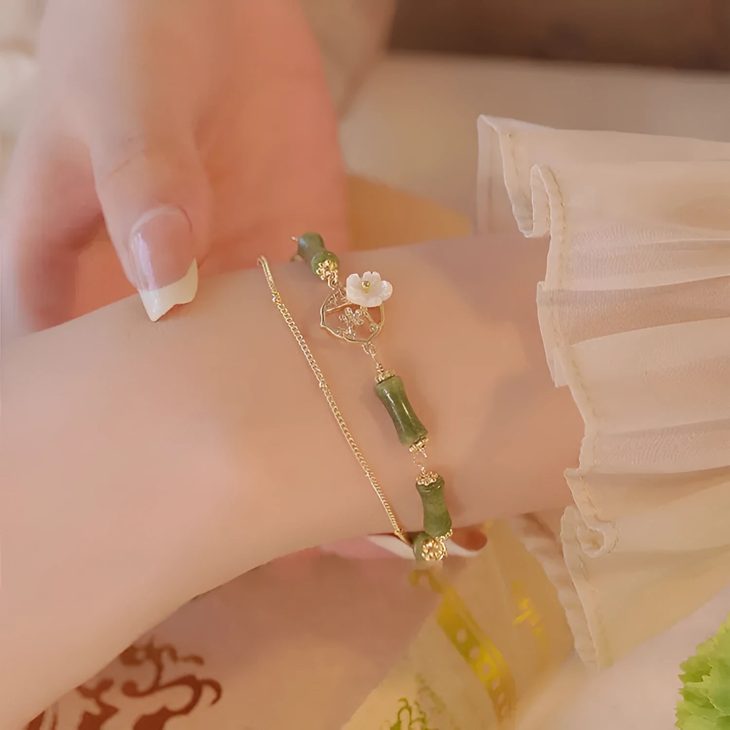 Natural olivine bracelet with double layer design featuring twin bells and olive branch motif