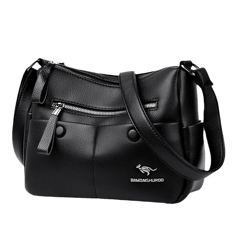 Women's soft leather crossbody bag in horizontal square shape with stitching details and crossbody strap
