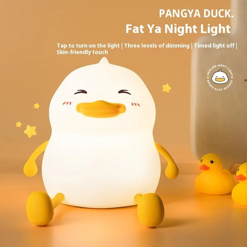Chubby Night Light TW-L73 on desk showing silicone phone holder with mobile device and adjustable brightness settings
