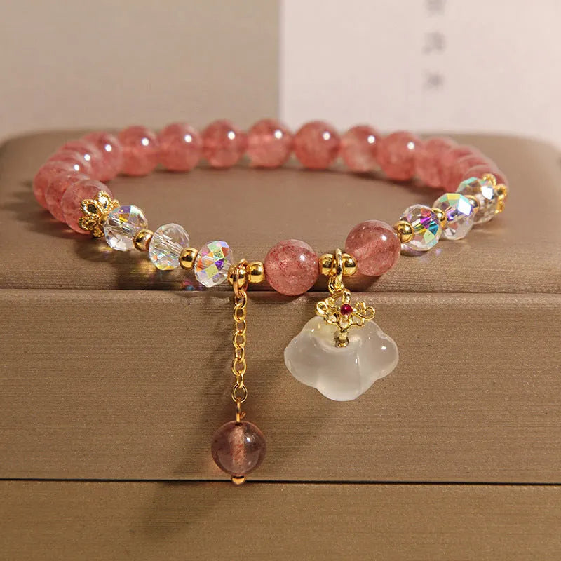 Women's strawberry quartz and white agate crystal bracelet with auspicious clouds charm.