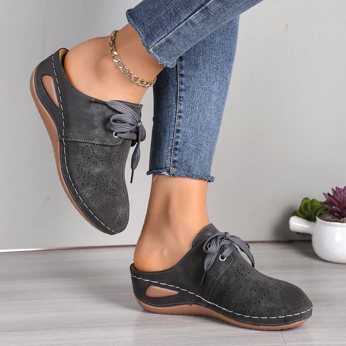 Women's Baotou lace-up slippers with hollow-out wedges in suede upper and rubber sole.