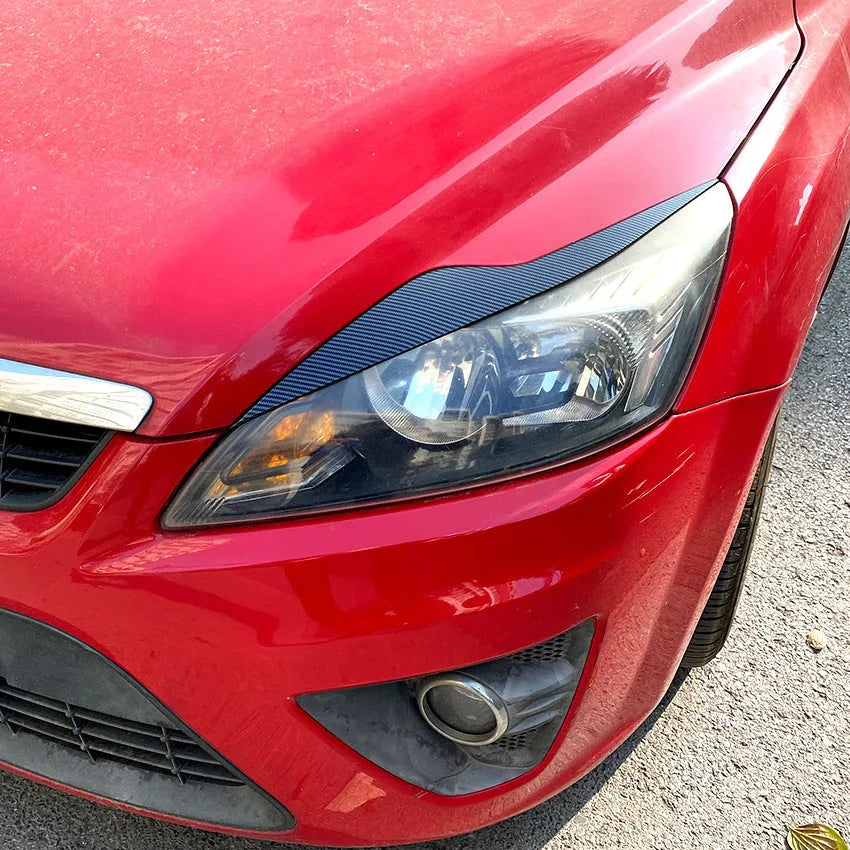 Ford Focus headlight eyebrow stickers in carbon fibre pattern and piano black finishes