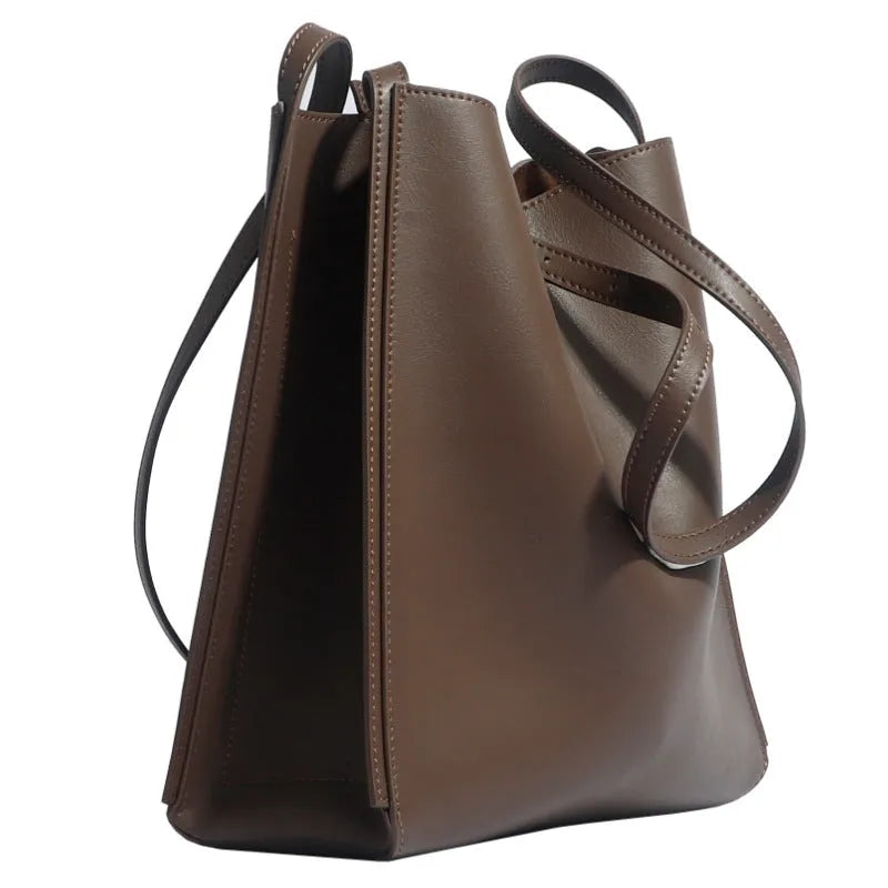 Genuine leather women's commuter bag in brown bucket design with organised internal compartments