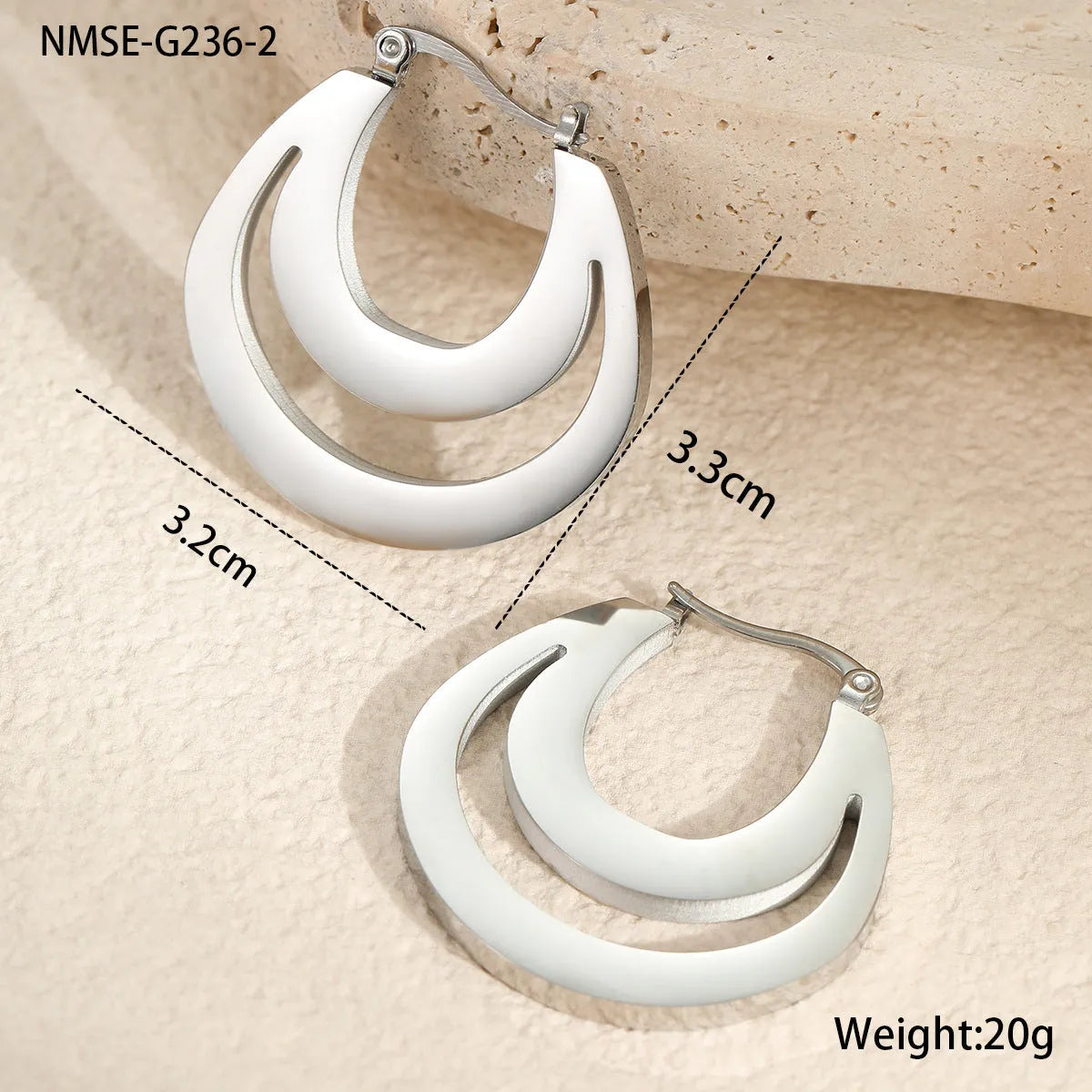 A pair of geometric minimalist French earrings in a round ring design, shown in both gold and steel metallic finishes.