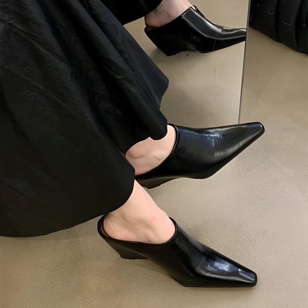 Women's black Wind Wedge closed toe half slippers with PU upper on a plain background.