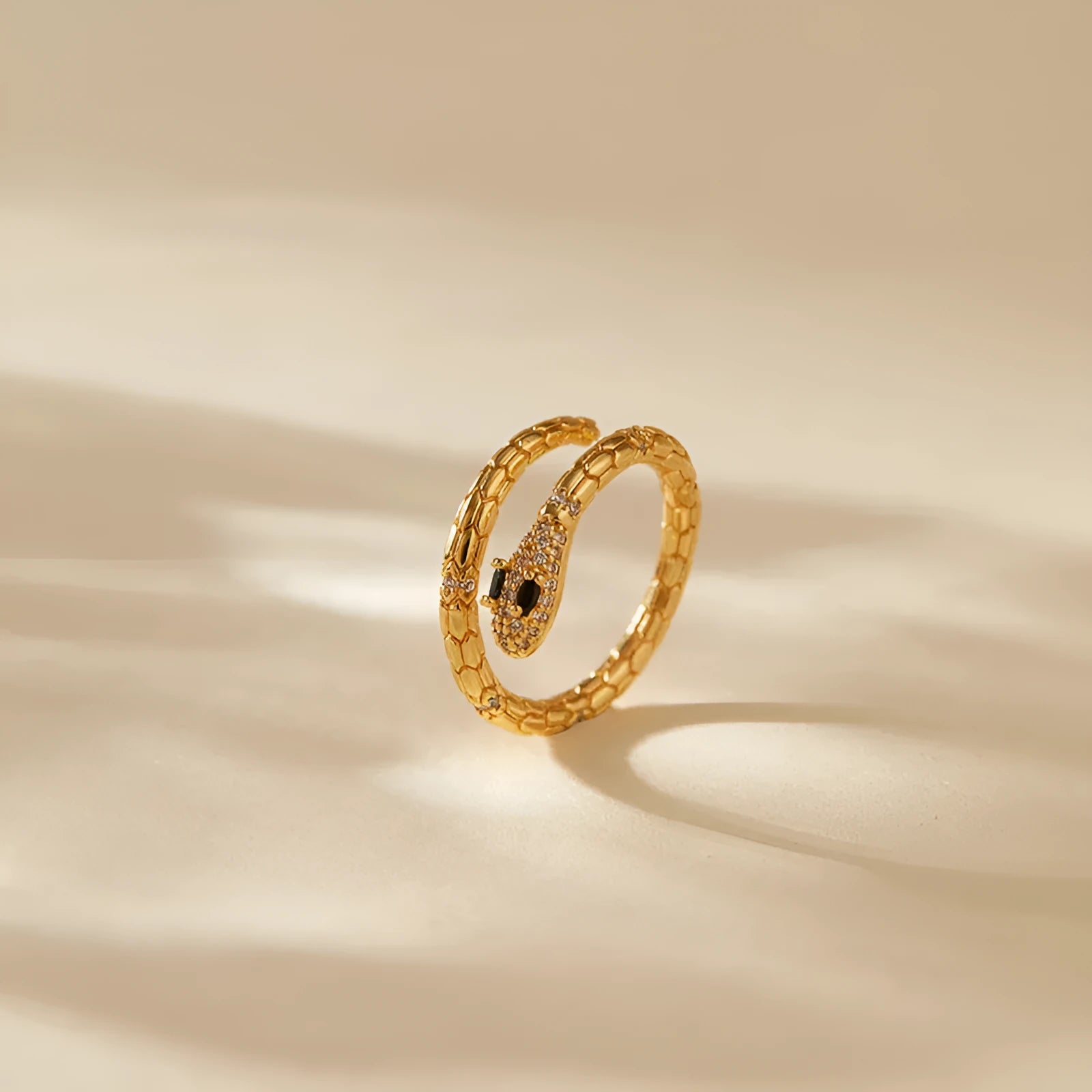 Gold coloured snake ring with open mouth design and adjustable opening