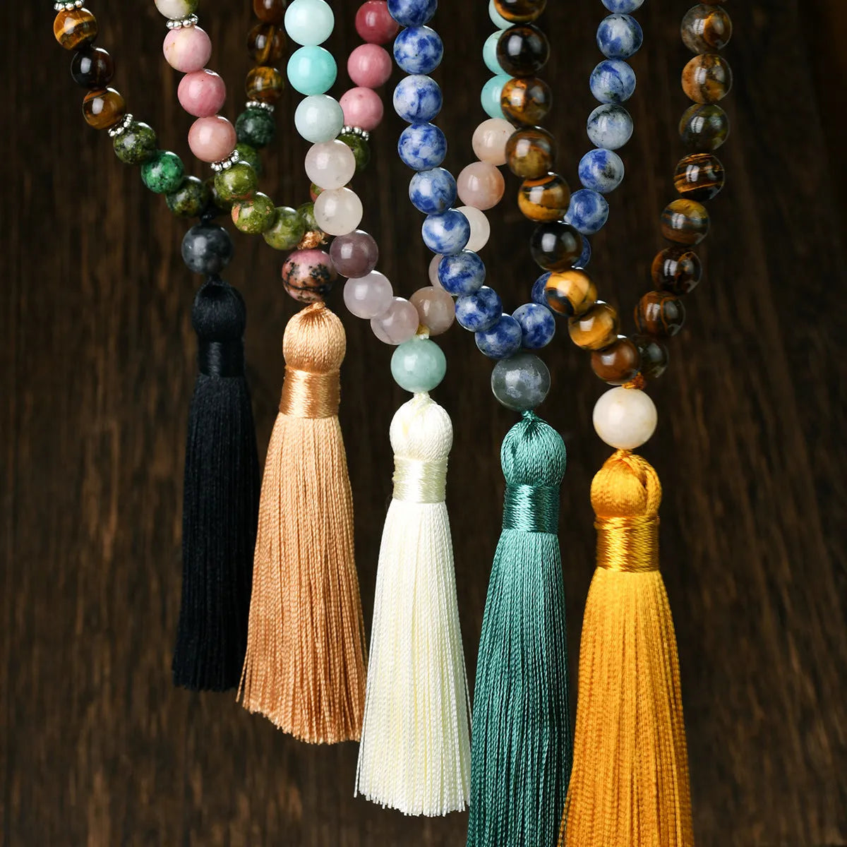 Long beaded bohemian necklace with 108 gemstone tassel pendants on a ball chain.