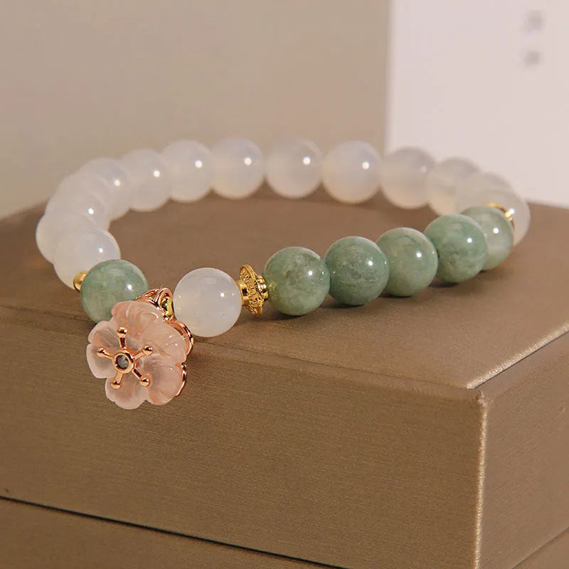 White agate jade bracelet with pink floral detailing and adjustable fastening