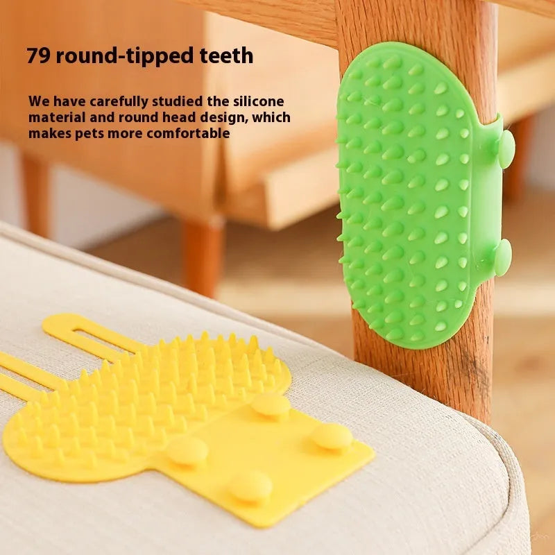 Black silicone cat grooming comb with adjustable strap attached to a table leg, showing rounded teeth for hair removal