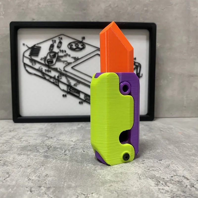 3D printed orange and green carrot-shaped gravity flick knife fidget toy on a white background.