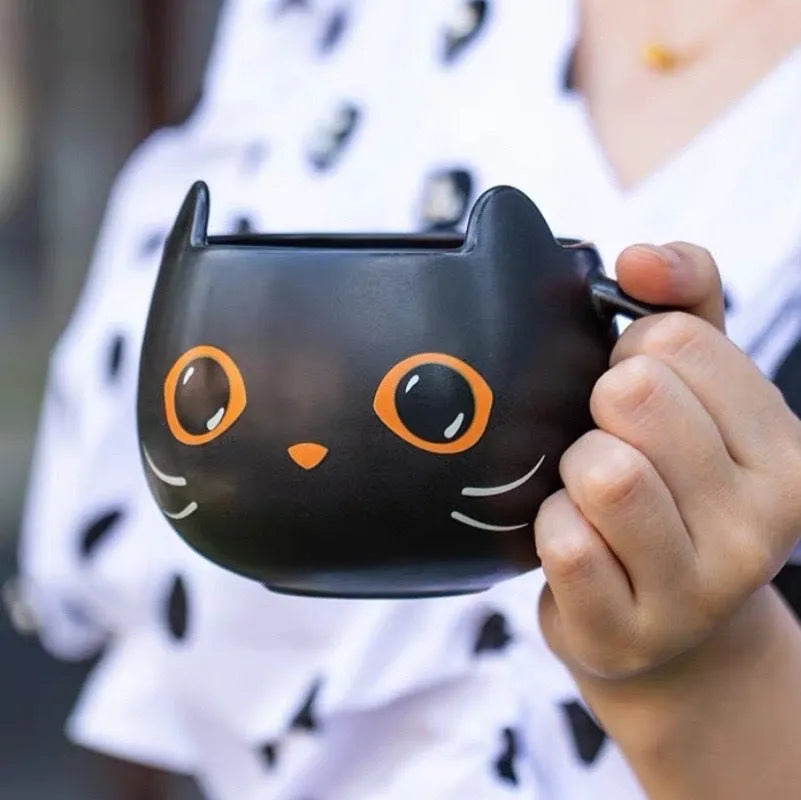 Black ceramic novelty mug with Halloween pumpkin, spoon couple, and cat design, 355ml capacity.