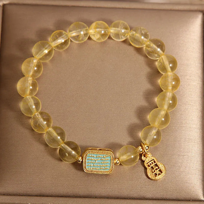 Yellow citrine crystal women's bracelet with rhinestone detailing on wrist