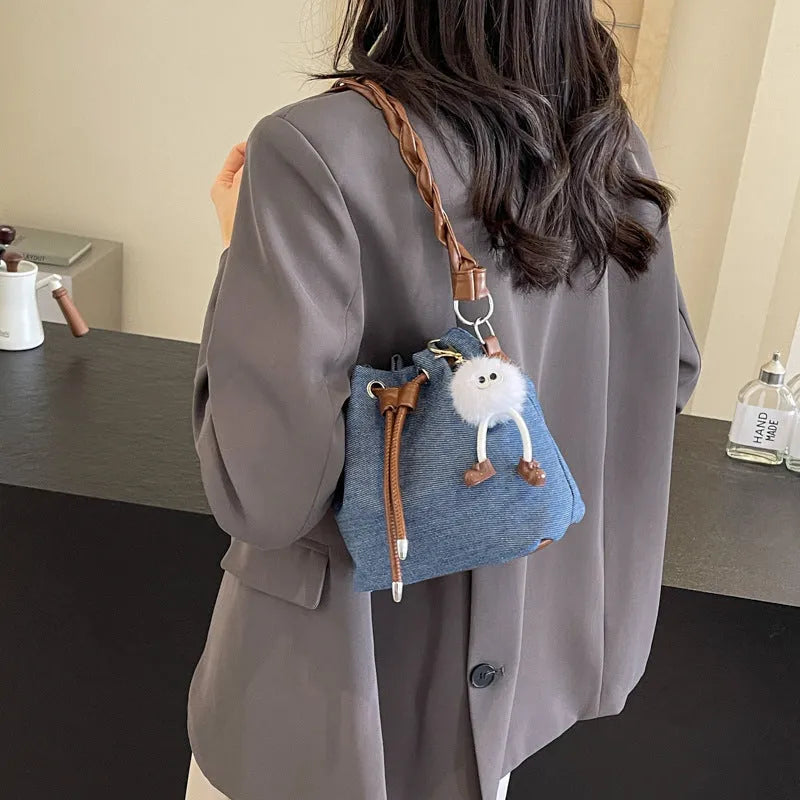 Blue one-shoulder cross body bucket messenger bag with a strap.