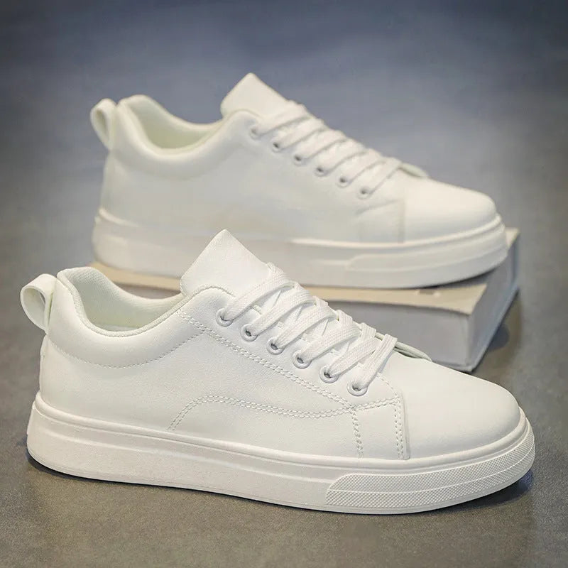 Men's low-top casual sneakers in black with white sole, showing round toe and flat heel design.